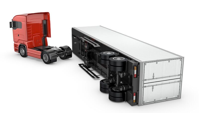 graphic of semi truck with a detached trailer lying on its side