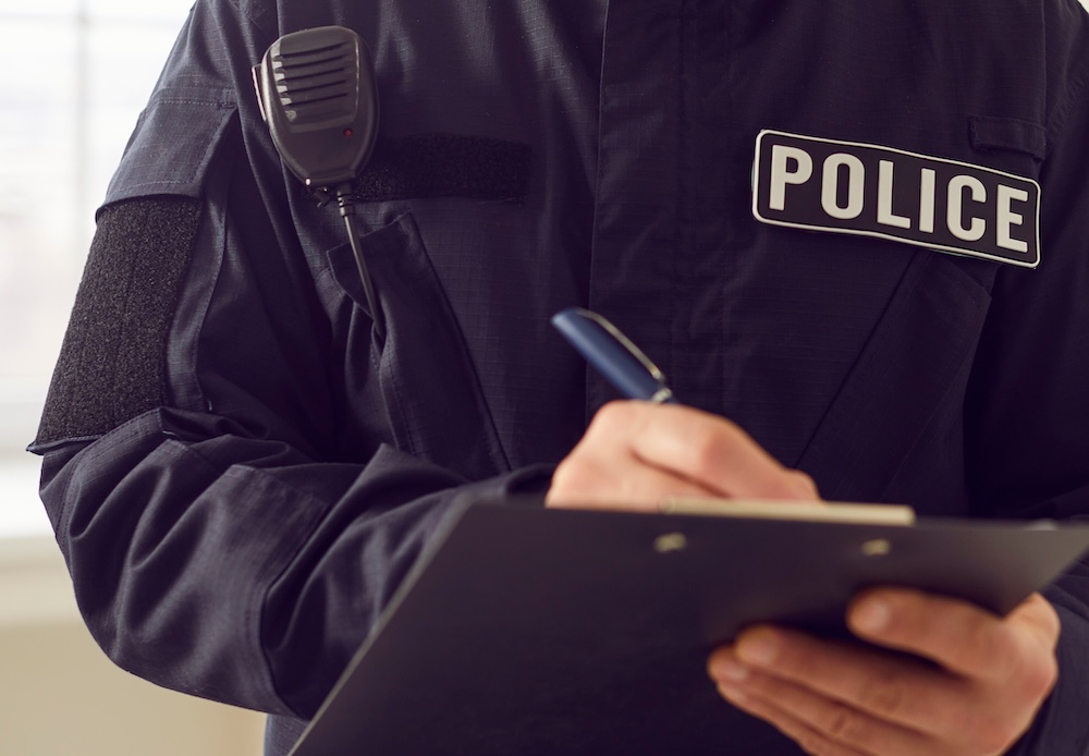 police officer writing a report.